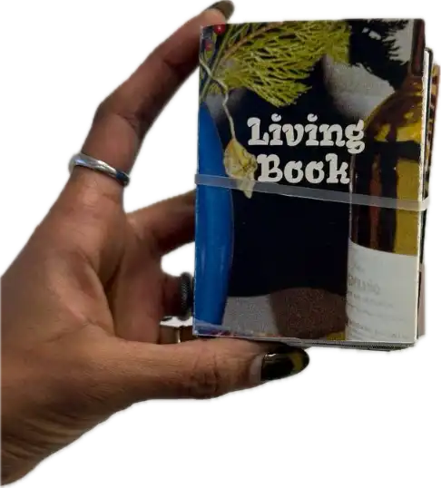 Hand holding Living Book edition 2